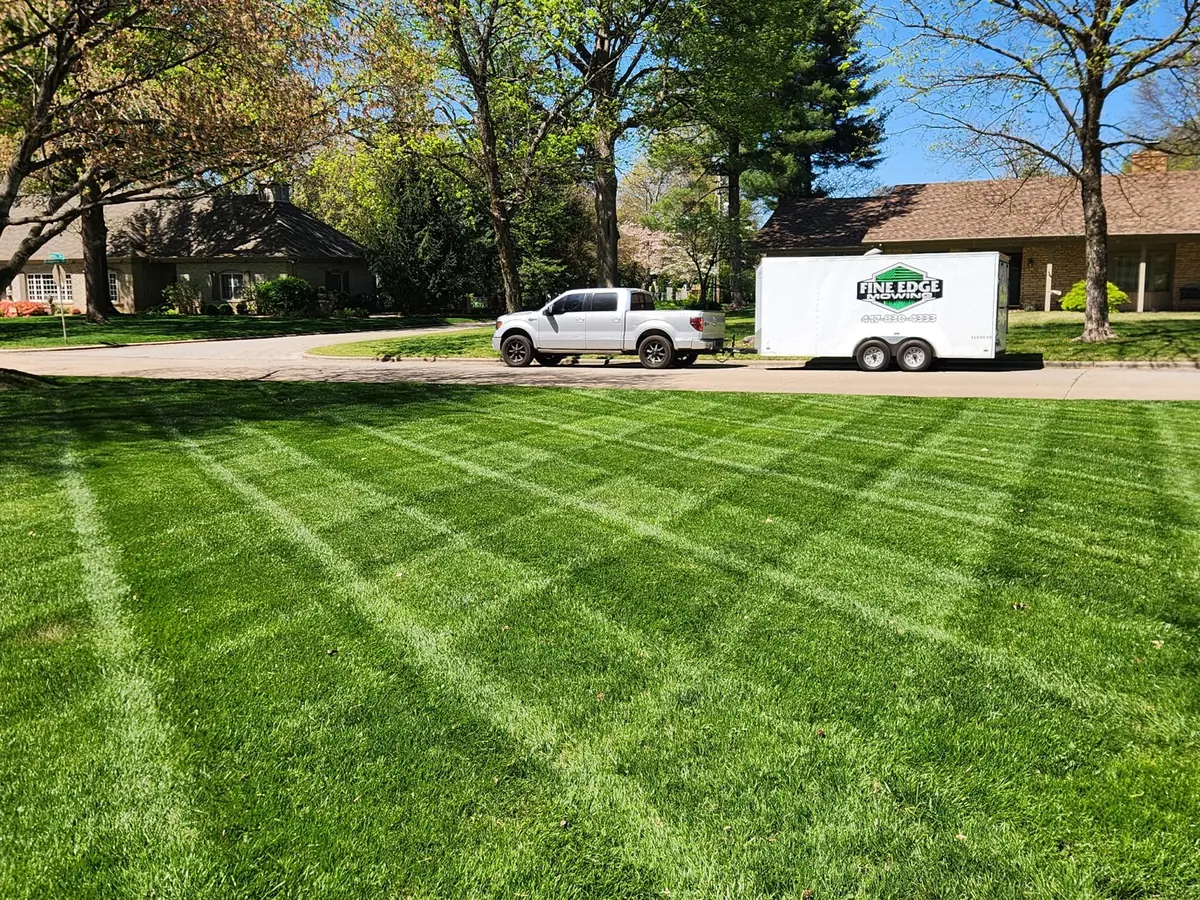 Finished striped lawn with the Fine Edge Mowing truck and trailer