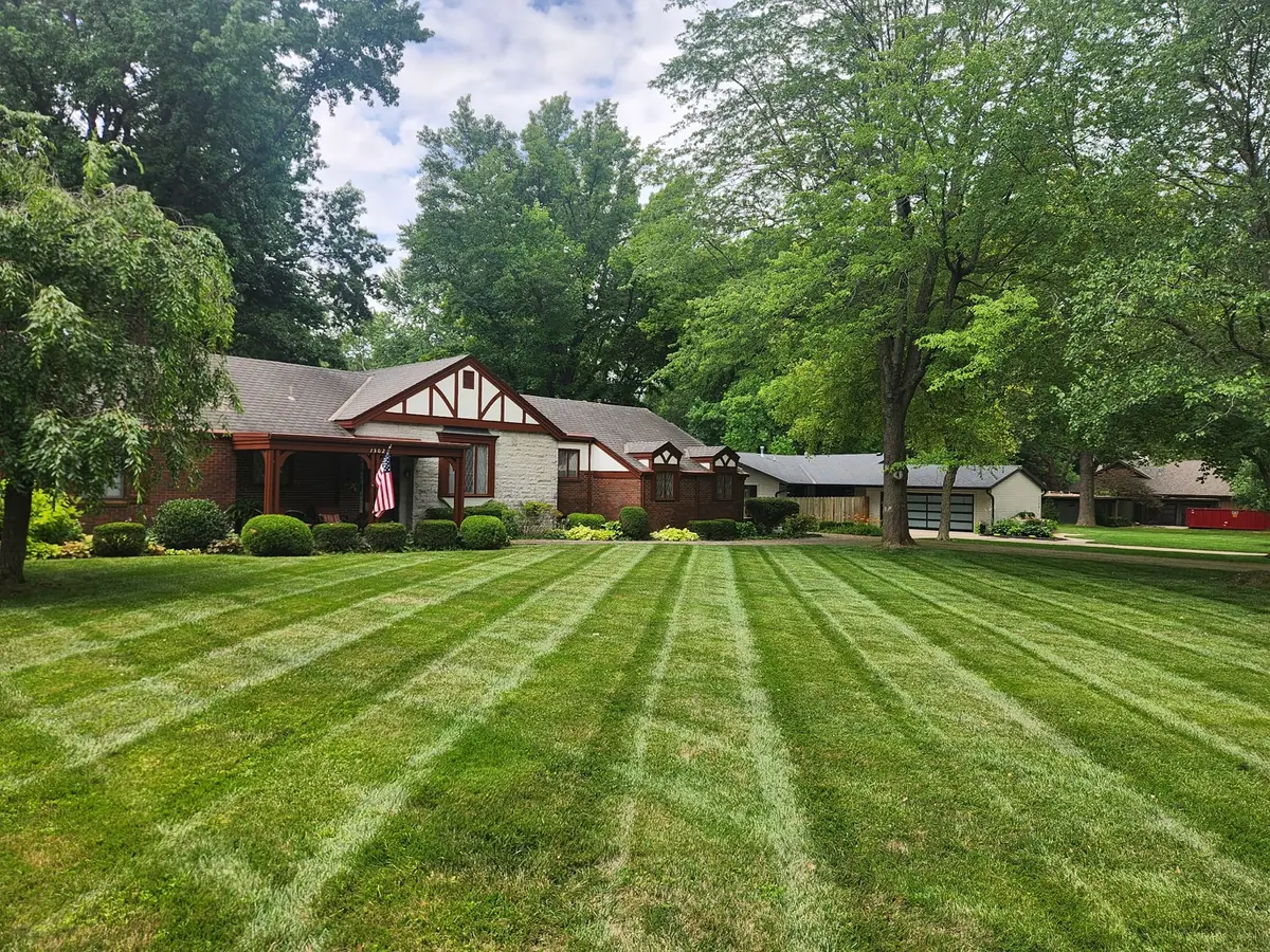Wide residential lawn with straight mowing stripes