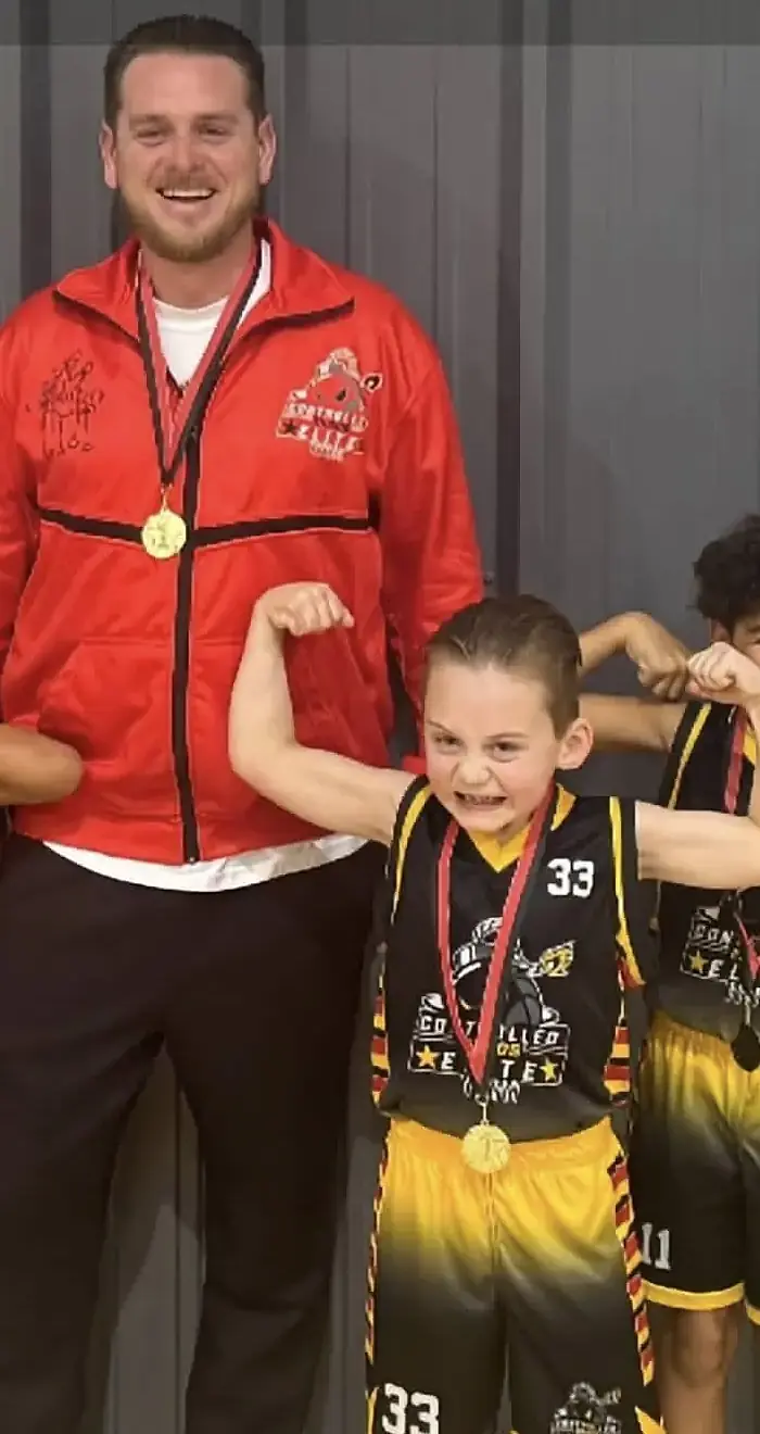 Matt Lane celebrating with young basketball players after a game