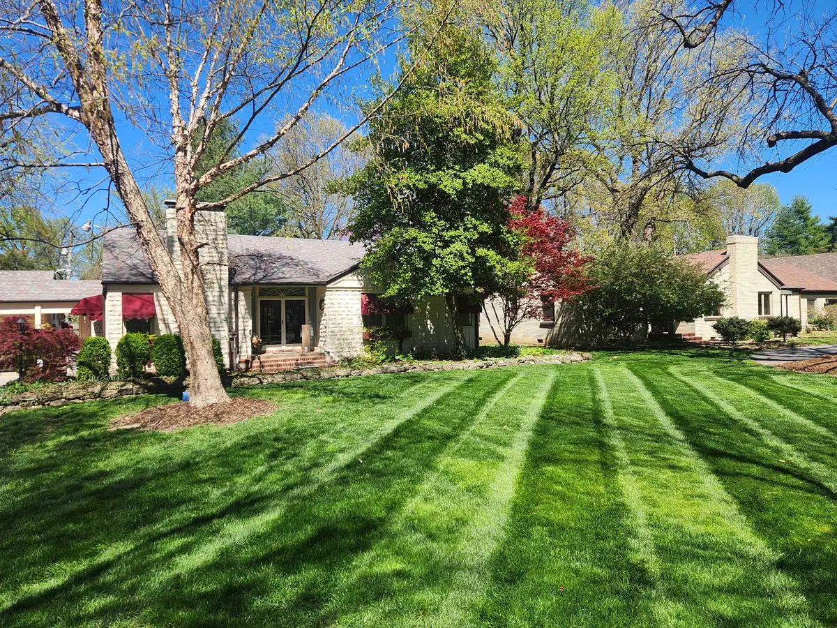 Bright spring lawn with clean parallel mowing lines